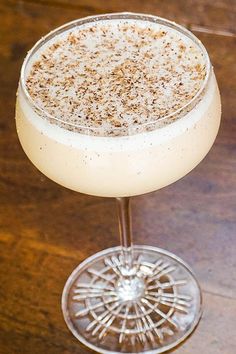 a drink sitting on top of a wooden table