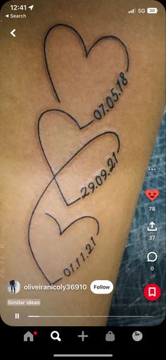 the back of a person's arm with two hearts on it and words written in cursive writing