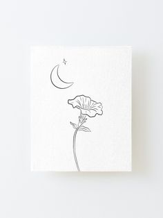 a drawing of a flower with a crescent moon in the background on a white paper