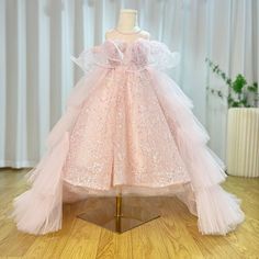 Discover the perfect dress for your little princess with DreamyVow's Sparkly Arabic Pink Girl Dress. Adorned with delicate beading and pearls, this gown is perfect for birthdays, weddings, and formal parties. Let your child shine in this stunning ball gown and make memories that will last a lifetime.