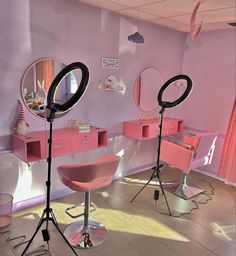 a room with pink furniture and mirrors on the wall