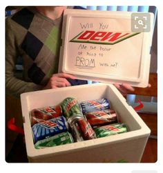 a young boy holding up a box of sodas and a sign that says, will you do me the hour or sing to prom with me?