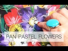 a hand holding a ring with flowers on it and the words pan pastel flowers