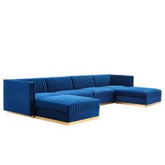 a blue sectional couch sitting on top of a white floor