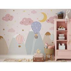 a child's room with a pink dresser and wallpaper that has hot air balloons on it