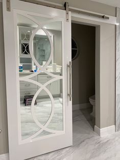 a bathroom with marble floors and white doors