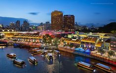 boats are docked in the water next to a large city at night with tall buildings