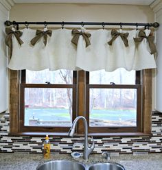 a kitchen window with two bow tie valances