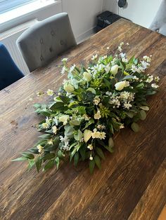 a bunch of flowers sitting on top of a wooden table