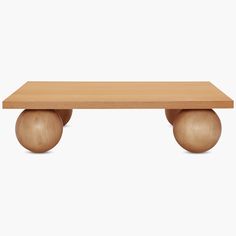 a wooden table sitting on top of a white floor next to a ball shaped object