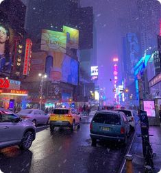 a city street filled with lots of traffic on a snowy day in the middle of winter