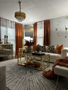 a living room filled with furniture and a chandelier