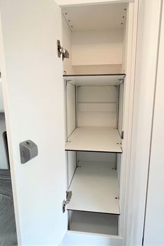 an empty white closet with shelves in it