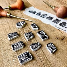 some stamps are sitting on a table next to a pair of scissors