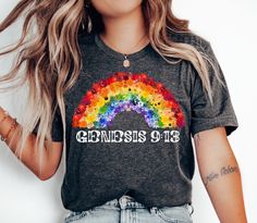 FREE SHIPPING. Genesis 9:13 Rainbow Tee. Sizes XS-4XL. This classic unisex jersey short sleeve tee fits like a well-loved favorite. Soft cotton and quality print make users fall in love with it over and over again. These t-shirts have-ribbed knit collars to bolster shaping. The shoulders have taping for better fit over time. Dual side seams hold the garment's shape for longer.  .: 100% Airlume combed and ringspun cotton (fiber content may vary for different colors) .: Light fabric .: Retail fit .: Tear away label .: Runs true to size Rainbow Crew Neck T-shirt For Pride, Rainbow Graphic Tee For Pride, Rainbow Letter Print T-shirt For Pride, Rainbow Letter Print Pride T-shirt, Pride Rainbow Pre-shrunk Top, Rainbow Colored Pre-shrunk Short Sleeve T-shirt, Rainbow Relaxed Fit Short Sleeve T-shirt, Christian Rainbow, Genesis 9 13