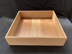 a wooden tray sitting on top of a black table