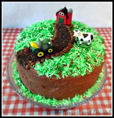 a cake decorated with green frosting and farm animals