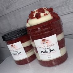 two jars filled with cake mix sitting on top of a table