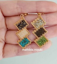 a pair of earrings that are made out of beads