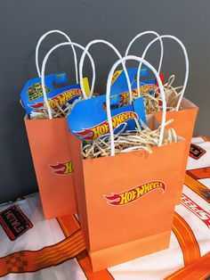 orange paper bags with hot wheels stickers on them