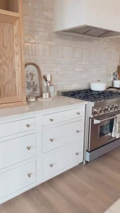 a kitchen with an oven, stove and cabinets in it's center island area