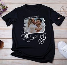 a black t - shirt with an image of a man and woman holding each other