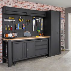 a workbench with tools on it in front of a brick wall and door