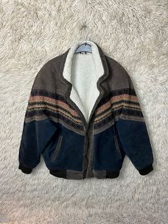 Lined vintage Navajo bomber jacket with teddy lining - made of suede with wool insert. Closes with snap buttons. There is a side pocket on the left and right, as well as an inside pocket, one with a zipper, one without. Colors: Brown, midnight blue, mustard yellow, orange, red Material: suede, wool-acrylic mix, lining: 100% polyester size 54 Size L (runs very large - more like XL!) Please note dimensions! Length: 79cm Width: 68cm Arm length from collar: 86 cm If you have any questions or need fu Colors Brown, Cute Fit, Vintage Navajo, Side Pocket, Yellow Orange, Mustard Yellow, Orange Red, Midnight Blue, Inside Pocket