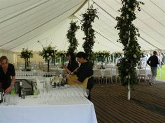 two women are sitting at a table with wine glasses