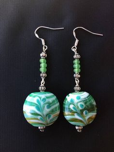 Floral print light green beads sterling silver fishhook earrings. Green Earrings For Jewelry Making, Handmade Green Beaded Earrings, Green Handmade Fun Earrings, Green Earrings With Colorful Beads, Handmade Green Beaded Dangle Earrings, Earring Design Ideas, Glass Bead Earrings, Lampwork Bead Jewelry, Diy Jewelry Earrings