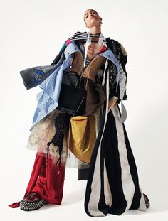 an image of a woman holding many clothes on her back and looking at the camera