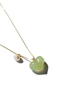 Necklace Nephrite The Puffed Heart Necklace features a green jade heart pendant, puffed to perfection, complemented by a delicate pearl. The unique puffed design of the jade heart adds a playful touch, making it an irresistibly cute accessory. Length: 17.5"Weight: 20gHeart pendant: 10mm x 13mm x 5mmMaterial: Nephrite, pearl, gold-plated sterling silver [#other] Product care Avoid knocking against hard surfaces. Jade pieces are brittle and will break when hit with hard objects. Make sure that you Elegant Heart-shaped Jade Jewelry, Green Pearl Drop Necklace Gift, Green Pearl Drop Necklace For Gift, Elegant Green Heart Pendant Necklace, Elegant Green Heart Beads Jewelry, Elegant Green Jewelry With Heart Beads, Puffed Heart Necklace, Go Swimming, Puffed Heart