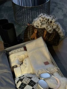 an open suitcase sitting on top of a floor next to a lamp and other items