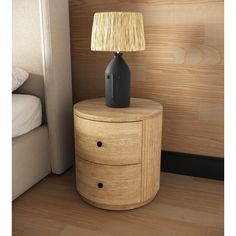 a night stand with a lamp on it next to a bed