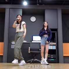 two young women standing in front of a microphone