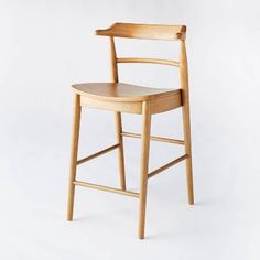 a wooden chair on a white background with no one in the room to see it