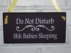 a sign that says do not disturb shh babies sleeping