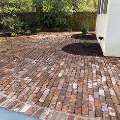 a brick walkway in front of a house