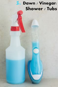 a blue and white bottle next to a red and white toothbrush on a counter