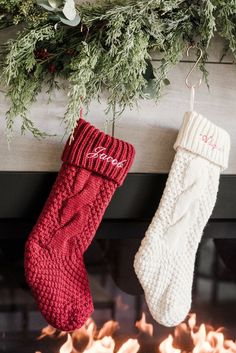 two christmas stockings hanging from a fireplace