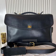 Add a touch of timeless elegance to your business attire with this Vintage 1980's Black Soft Leather Coach Lexington Briefcase and Business Bag. Crafted with premium quality leather, this #5265 classic piece exudes sophistication and style. The adjustable crossbody removable strap offers versatility and comfort for your daily commute or business meetings. A perfect blend of functionality and vintage charm, this Coach briefcase is sure to turn heads wherever you go. Make a statement with your accessory choice and elevate your professional look with this exquisite bag. Vintage 1980's Black, Soft Leather Coach, Lexington Briefcase and Business Bag with Adjustable Crossbody Removable Strap, #5265. This was my privately owned briefcase which sat in a plastic bag for many years. I originally pur Timeless Formal Briefcase With Gold-tone Hardware, Formal Briefcase Satchel With Gold-tone Hardware, Formal Satchel Briefcase With Gold-tone Hardware, Formal Satchel-style Briefcase With Gold-tone Hardware, Vintage Formal Briefcase With Gold-tone Hardware, Elegant Formal Briefcase With Gold-tone Hardware, Vintage Formal Briefcase With Detachable Strap, Designer Briefcase With Detachable Strap For Formal Use, Designer Formal Briefcase With Detachable Strap