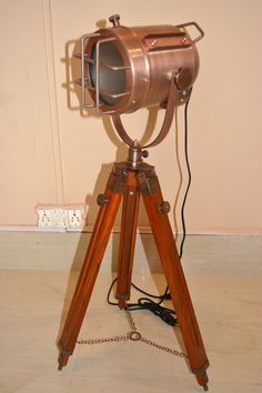 an old fashioned camera on a tripod with a chain attached to the legs and head