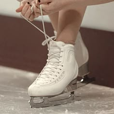 a person sitting on top of a pair of ice skates