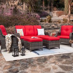 an outdoor patio furniture set with red cushions