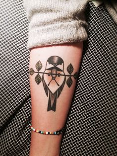 a woman's arm with a tattoo on it and an arrow in the middle