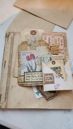 an old envelope is covered with papers and other things to make it look like they have been mailed