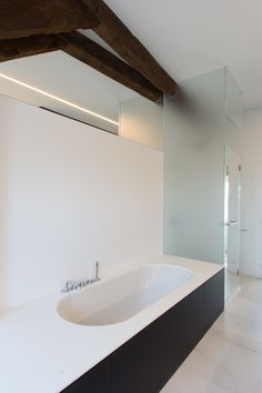 a bathroom with a large white bathtub sitting next to a walk in shower stall