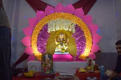 there is a statue in the middle of a stage decorated with flowers and other decorations