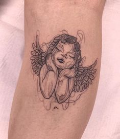 an angel tattoo on the leg