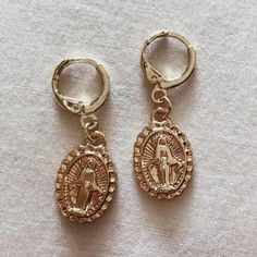 The Virgin Mary symbol engraved into these minimalist earrings touches on immaculate purity and Mary's prerogative as the divinely blessed model and mediatrix. These engraved coin earrings are your perfect go-to piece. Wear them paired with your other favorite jewelry pieces. Genuine 14k Gold Plated Engraved Virgin Mary Handmade Gold Engraved Symbolic Earrings, Symbolic Engraved Gold Earrings, Engraved Gold Symbolic Earrings, Mary Symbol, Gold Coin Earrings, Urban Outfitters Jewelry, Coin Earrings, The Virgin Mary, Gold Coin